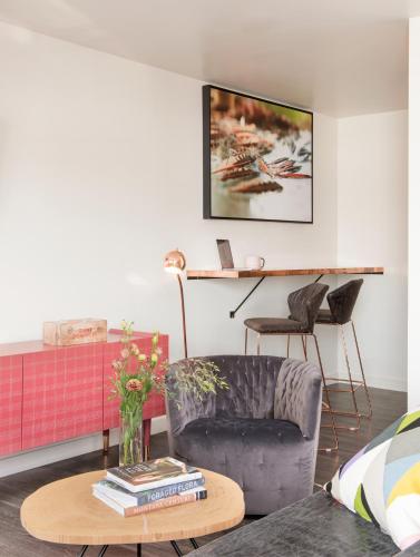 a living room with a chair and a table at RSVP Hotel in Bozeman