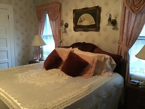 a bed with pillows on it in a bedroom at Brookview Manor Inn in Canadensis