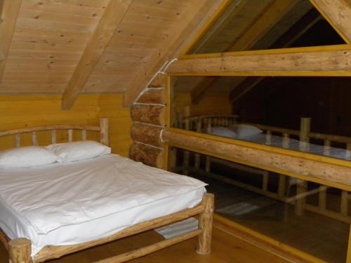 a bedroom with two bunk beds in a cabin at Farmhouse Rosehip Flower Romania Brasov in Râşnov