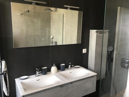 a bathroom with a white sink and a mirror at Résidence Le Château - Parc Santa Lucia in Saint-Raphaël