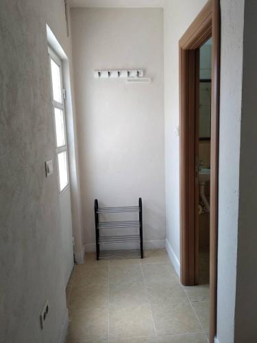 a hallway with a bench in a white room at Sweet Dream Rooms in Podgorica