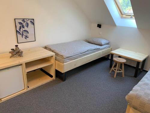 a small bedroom with a bed and a desk at Treehouse Apartments in Martinske Hole