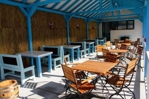 a row of tables and chairs on a patio at Pensiunea La Marcu Modern in Tulcea