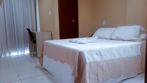 Cama ou camas em um quarto em Aracaju Corais Hotel