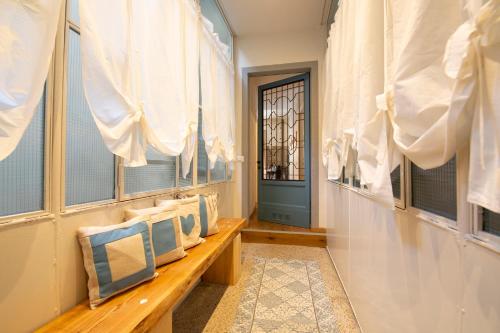 a hallway with a bench with pillows and a door at Casa Vacanze Gombito 4 Bergamo Alta in Bergamo