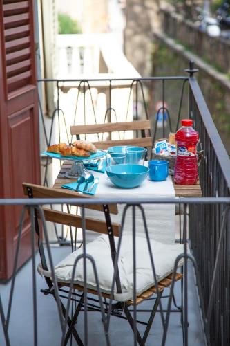 a table with bowls and plates of food on a balcony at Casa Vacanze Gombito 4 Bergamo Alta in Bergamo