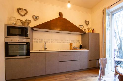 a kitchen with a sink and a stove at Casa Vacanze Gombito 4 Bergamo Alta in Bergamo