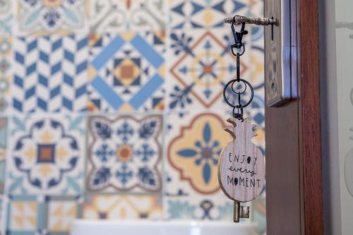a keychain hanging from a door in a bathroom at Mostarda Boutique Apartment in Vila do Conde