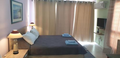 a bedroom with a bed and a lamp and a window at EMILIA 11 STUDIO in Polis Chrysochous