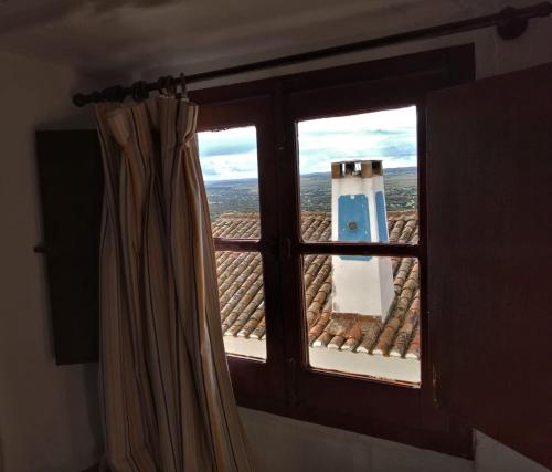 a window with a view of a roof at Casa D’ Santiago in Monsaraz