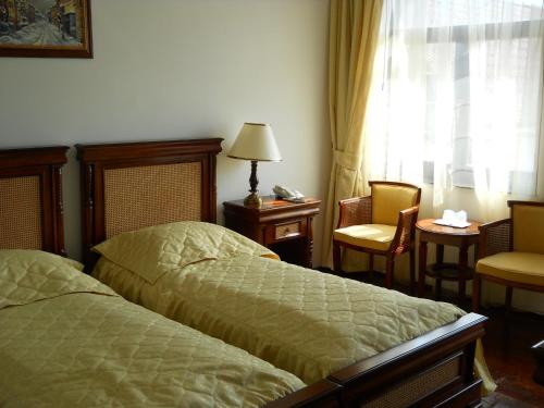 A bed or beds in a room at Casa Domneasca