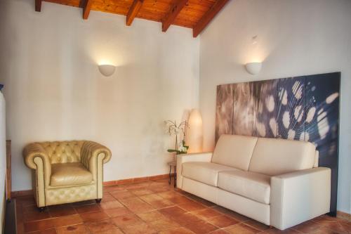 a living room with a couch and a chair at Moonshine Guest House with private studios and private cottage in Lagos