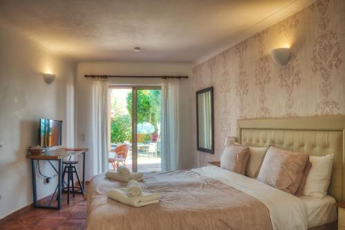 a bedroom with a bed with two towels on it at Moonshine Guest House with private studios and private cottage in Lagos