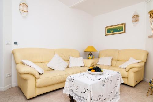 a living room with a couch and a table at Apartments Carmen & Tosca in Dubrovnik