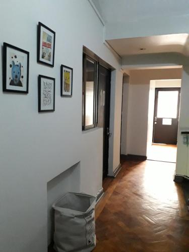a living room with a white wall with a fireplace at Atacama Hostel Backpackers in Santiago