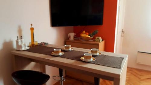 a table with coffee cups on top of it at River View Apartment Gospic in Gospić