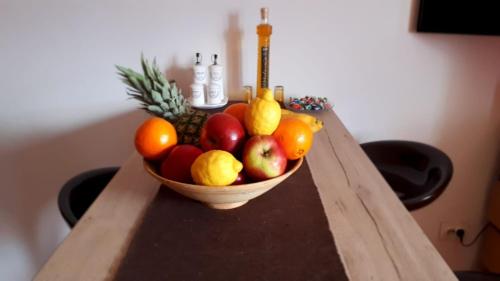 a bowl of fruit on a wooden table at River View Apartment Gospic in Gospić