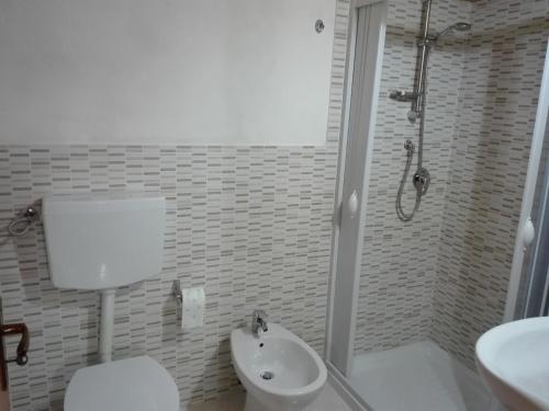 a bathroom with a shower and a toilet and a sink at La casa di Anita nel cuore di Segesta in Calatafimi