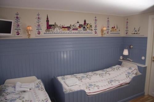 a bedroom with a bed and a table in it at Garvaregården Hotel , B&B och Café in Askersund