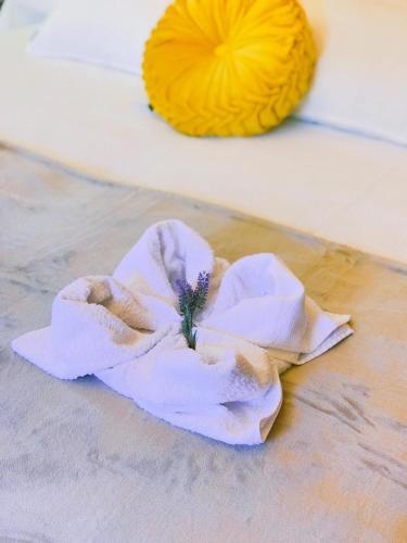 a white towel on the floor next to a pumpkin at A Casa da Botica in Samos