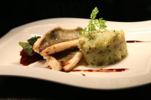a white plate of food with meat and mashed potatoes at The Rock Inn in Bovey Tracey