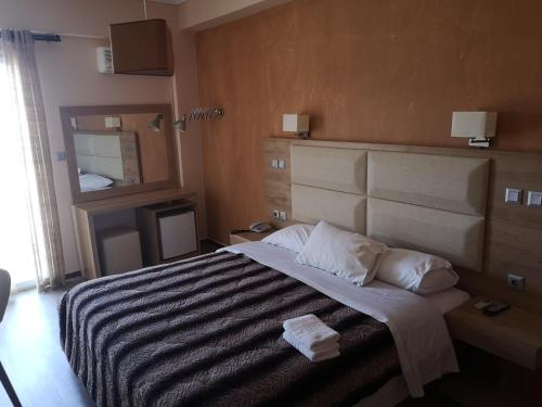 a bedroom with a bed with two towels on it at Idillion in Vília