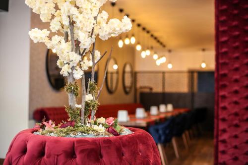 a table with a vase with white flowers on it at Thermal Saray Hotel & Yalova in Gokcedere