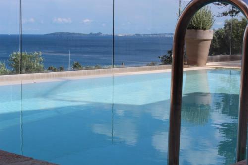 a swimming pool with a view of the water at Villa Renata Gold in Barbati