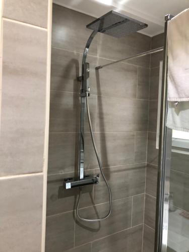 a shower with a shower head in a bathroom at Porticcio centre plage à pieds, studio-cabine 4 Pers max, promo 7 nuits in Porticcio
