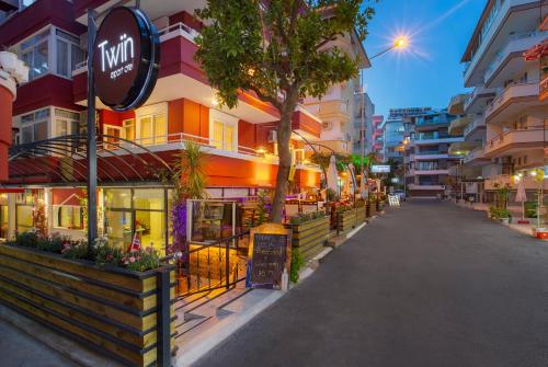 an empty street in a city with buildings at Twin Apart Hotel in Alanya