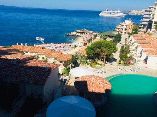 a view of a beach with umbrellas and the ocean at The Bay Apartments in Sarandë