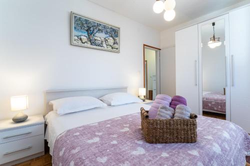 a bedroom with a bed with a chair on it at Sunny House in Korčula