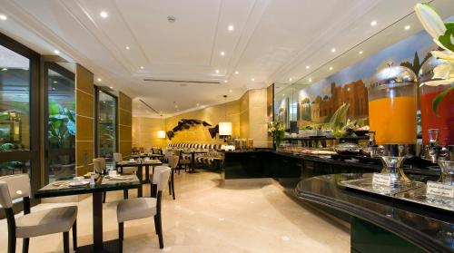 a restaurant with tables and chairs and a bar at Hotel dei Mellini in Rome