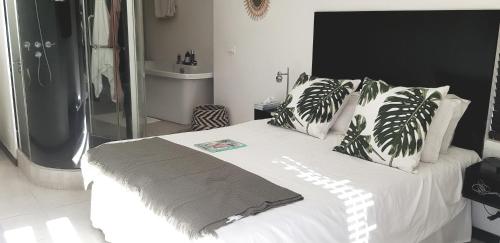 a bedroom with a bed with white sheets and pillows at Beach Apartment - Trou aux Biches - Ground Floor in Mont Choisy