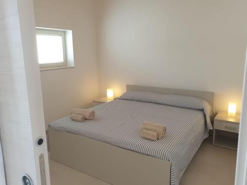 Postel nebo postele na pokoji v ubytování A(m)mare - casa vacanze