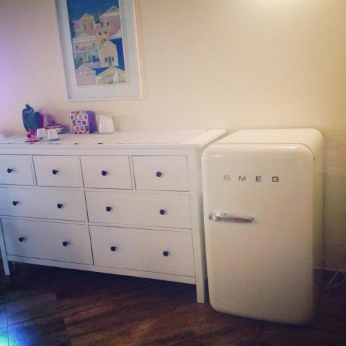 a white refrigerator in a room with a dresser at Bed&Breakfast La Zagara in Querceta