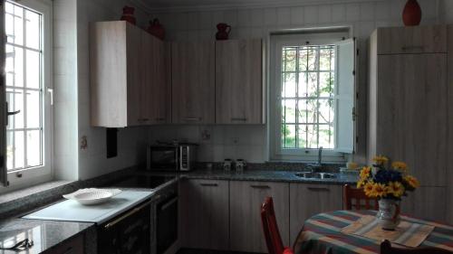 a kitchen with wooden cabinets and a table with a table sidx sidx sidx at Casa Braña in Barreiros
