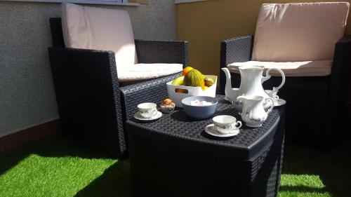 a table with cups and tea pots on it at Cabo de Palos apartamento vacacional in Cabo de Palos