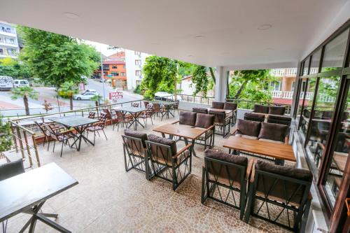 a patio with tables and chairs on a balcony at Thermal Saray Hotel & Yalova in Gokcedere