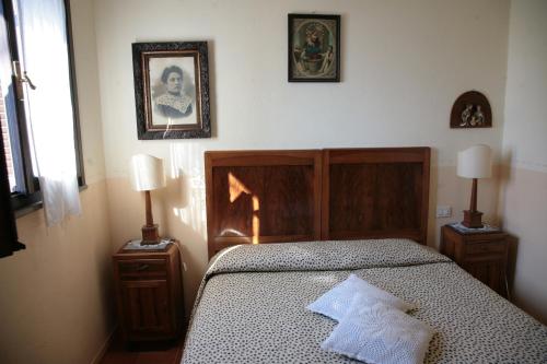 a bedroom with a bed and two lamps and a picture on the wall at Malvarina in Capodacqua