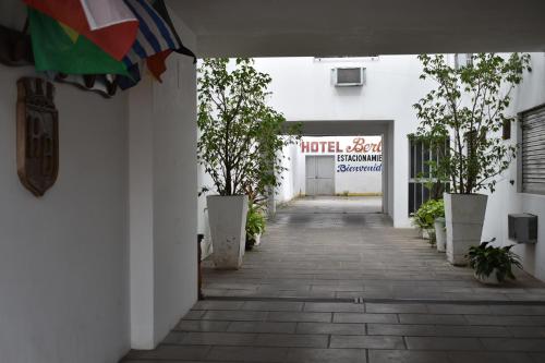 an empty hallway with trees in front of a building at Hotel Berlin in Gualeguaychú
