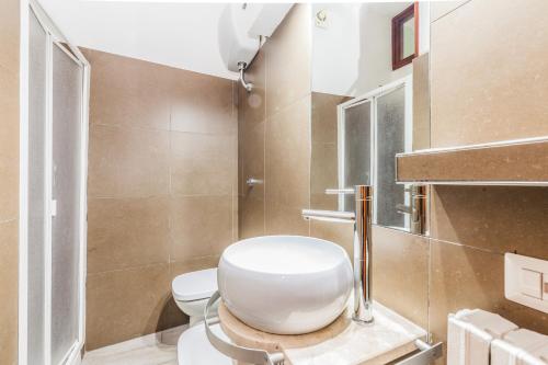 a bathroom with a white toilet and a sink at Albergo Della Corte in Benevento