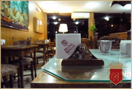 a glass table with a laptop on top of it at Hotel Berlin in Gualeguaychú