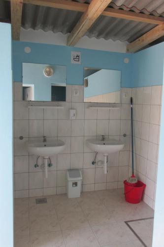 a bathroom with two sinks and a mirror at Caravan near the sea in Ugljan