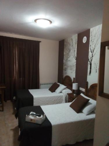 a hotel room with two beds and a couch at Casa Favila in Potes