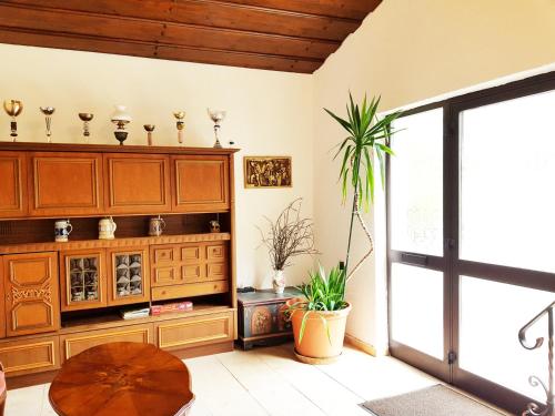 a living room with a wooden cabinet and a table at Aparthotel Pan Haus in Bad Ischl