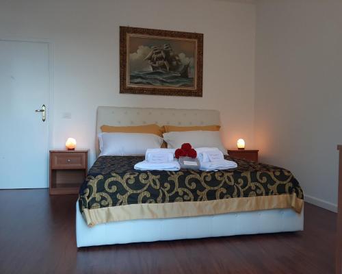 a bedroom with a bed with two towels on it at Carpe Diem Ancona in Ancona