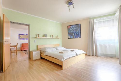 a bedroom with a bed and a mirror at H-Apartments in Trier