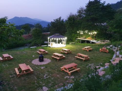 a group of picnic tables and a gazebo at Pyeongchang Healing Stay in Pyeongchang
