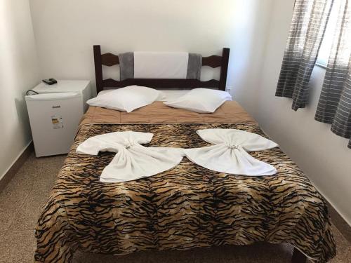 A bed or beds in a room at Pousada do Genesio